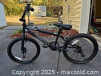 Full side view of black 20-inch Mongoose boys bicycle