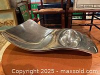 Oblique view of Nambe chip and dip platter showing curved form and integrated dip bowl