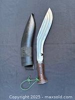 Knife and sheath side by side showing full lot