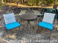 Overall view of table and two chairs with cushions