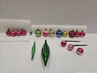 Full grouping of all miniature glass ornaments arranged on paper towels