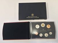 Outer sleeve and open presentation case showing coins