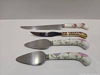 All four serving pieces laid out showing full length and handles