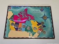 Front view of sealed Canada 125 coin set on map card