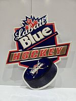 Full view of Labatt Blue metal hockey sign