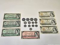 Overview showing 3 Centennial $1 notes, 3 other $1 notes, $2 note, 4 dollar coins, 2 half dollars, 7 quarters