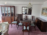 Overall view of dining set: table with six chairs, china cabinet, sideboard