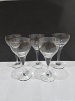 Five identical clear Rosenthal liqueur glasses front view
