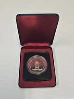 Coin in presentation case, lid open