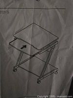assembly instruction sheet showing desk design with tray and casters