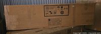 Large sealed cardboard box containing Bush Furniture Cabot 60W hutch