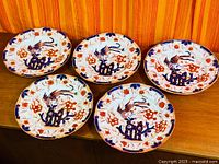 All five matching Imari-style plates displayed together