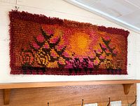 Full view of rug mounted on wall showing design