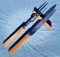 Knife and fork side by side on blue fabric