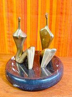 Front view of both bronze figures on marble base