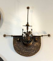 Frontal view of entire bronze and cloisonné wall sculpture mounted on wall