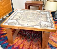 Oblique view of teak coffee table showing tile top and legs