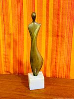 Full view front of bronze figure on marble base