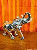 Left side profile of silver resin elephant