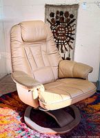 Full view of cream leather swivel armchair on colourful rug