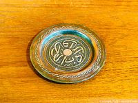 Full view of copper dish front showing inlaid design