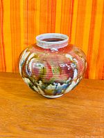 Front view of bulbous multicolour glaze vase