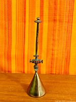 Full view of bronze cone bell with tall stem