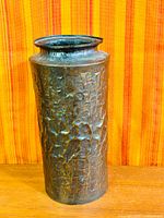 Front view of hammered copper vase with patina