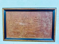 Front view of framed tooled leather wall art