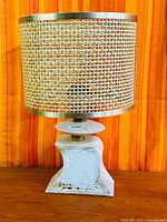 Full view of travertine lamp with cane shade