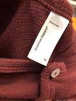 Maroon shirt close-up showing American Apparel tag, size M, waffle knit texture, buttons