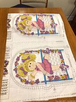 Full view of two printed ballerina panels on fabric showing design and instructions strip