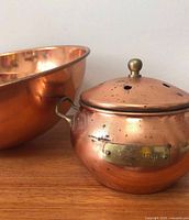 Copper potpourri jar with lid beside largest mixing bowl