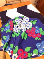 Floral fabric draped over navy/white fabric on table