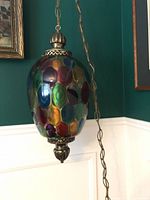 Full view of hanging glass swag lamp with chain