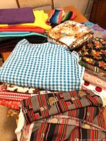 Stacks of assorted fabric pieces on table