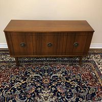 Full front view of wood credenza on rug