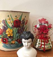 Metal floral waste can, porcelain doll head, floral globe grouped