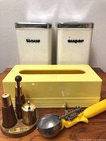 Front view showing both canisters, tissue cover, condiment set and scoop