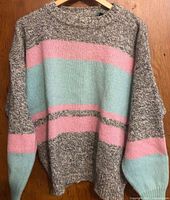 Full view of sweater front on hanger