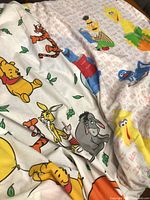 Winnie The Pooh and Sesame Street printed sheets close-up