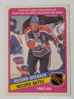 Front of Wayne Gretzky Record Breaker card showing image, team colors, pink header, NHL logo