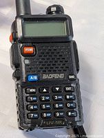 Front view showing screen, keypad, model and control buttons