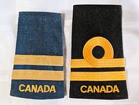 Blue and black Canadian rank slip-ons side by side