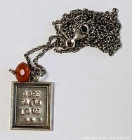 Necklace coiled displaying clasp and pendant