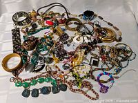 Full spread of assorted jewelry pieces on cloth