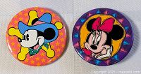 Both Mickey and Minnie Mouse buttons front view