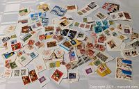 Overall view of large pile of mixed world stamps on paper