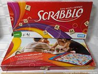 Box top open showing Scrabble branding and inner lid