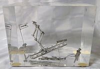 Front view of lucite block showing metal skier